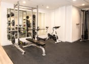 Thumbnail 31 of 42 - a gym with exercise equipment and weights on the floor