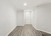 Thumbnail 14 of 35 - A room with a white door and a light on the ceiling.
