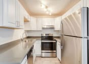 Thumbnail 2 of 24 - a kitchen with white cabinets and stainless steel appliances