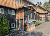 Thumbnail 28 of 28 - A building with a brown and black exterior and a sign that reads "2412 788".