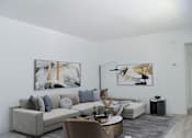 Thumbnail 12 of 20 - a living room with a couch and a table