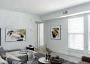 Thumbnail 11 of 20 - a living room with gray walls and white trim