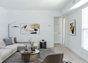 Thumbnail 8 of 20 - a living room with a couch and a table