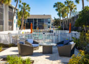 Thumbnail 2 of 43 - an outdoor patio with chairs and tables next to a pool