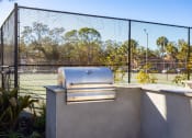 Thumbnail 35 of 43 - a grill on a wall next to a tennis court with a fence