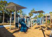 Thumbnail 37 of 43 - a playground with a slide and two umbrellas