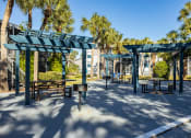 Thumbnail 7 of 43 - a park with picnic tables and awnings