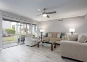 Thumbnail 13 of 43 - a living room with couches and chairs and a ceiling fan