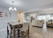 Thumbnail 10 of 43 - an open living room and dining room with a table and chairs