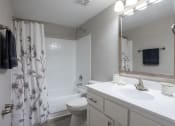 Thumbnail 21 of 43 - a bathroom with a shower and a sink and a toilet