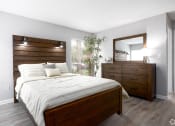 Thumbnail 22 of 43 - a bedroom with a bed and a dresser