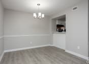 Thumbnail 26 of 43 - an empty living room with white walls and wood flooring