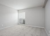 Thumbnail 29 of 43 - an empty room with a large window and white walls