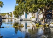Thumbnail 38 of 43 - a body of water surrounded by houses and trees