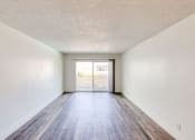 Thumbnail 8 of 24 - an empty living room with white walls and wood floors