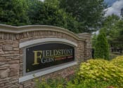 Thumbnail 1 of 34 - a stone wall with a sign for the fieldstone glen amphitheater park