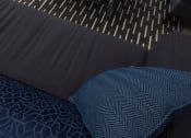 Thumbnail 28 of 34 - a dark blue couch with a blue pillow on it