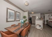 Thumbnail 21 of 34 - a dining room with a wooden table and leather chairs