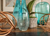 Thumbnail 16 of 34 - a group of glass vases sitting on top of a wooden table