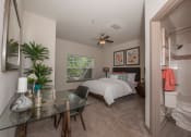 Thumbnail 18 of 34 - a bedroom with a bed and a glass desk
