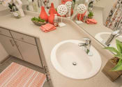Thumbnail 13 of 34 - a bathroom with a sink and a mirror