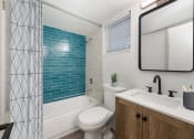 Thumbnail 11 of 33 - a bathroom with a shower curtain and a toilet and a sink