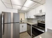 Thumbnail 33 of 33 - a kitchen with stainless steel appliances and white cabinets