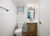 Thumbnail 30 of 33 - a small bathroom with a toilet sink and mirror