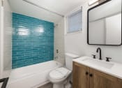 Thumbnail 28 of 33 - a bathroom with a sink toilet and a bath tub