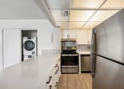 Thumbnail 22 of 33 - a kitchen with stainless steel appliances and white cabinets