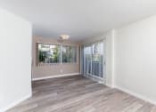 Thumbnail 5 of 9 - a bedroom with hardwood floors and white walls