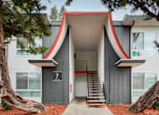 Thumbnail 27 of 36 - a building with a large asymmetrical doorway and a staircase in front of it