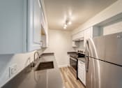 Thumbnail 5 of 36 - a kitchen with stainless steel appliances and white cabinets