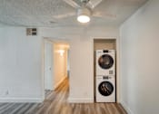 Thumbnail 10 of 36 - a living room with a washer and dryer
