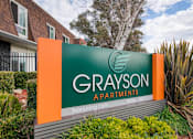 Thumbnail 35 of 36 - a sign with a green background and an orange background with the words grayson apartments