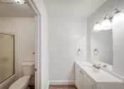 Thumbnail 9 of 36 - a bathroom with a toilet sink and mirror