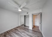 Thumbnail 7 of 36 - a bedroom with hardwood flooring and a ceiling fan