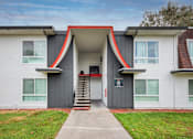 Thumbnail 31 of 36 - a building with grey and red walls and a staircase in front of it