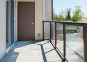 Thumbnail 19 of 42 - a balcony with a wooden railing and a large glass door
