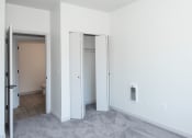 Thumbnail 17 of 42 - an empty room with a door to a bathroom and a closet