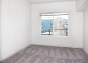 Thumbnail 15 of 42 - an empty room with a window and carpeting