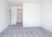 Thumbnail 14 of 42 - an empty living room with white walls and carpet