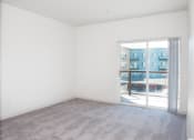 Thumbnail 12 of 42 - an empty living room with a door to a balcony