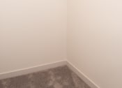 Thumbnail 10 of 42 - a room with white walls and a closet with white rods on the ceiling