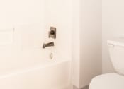 Thumbnail 8 of 42 - a bathroom with a white toilet and a tub and a sink