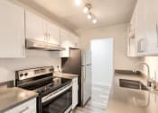 Thumbnail 4 of 24 - a kitchen with white cabinets and stainless steel appliances