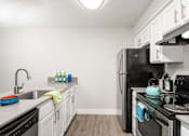 Thumbnail 23 of 25 - a kitchen with white cabinets and black appliances