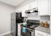 Thumbnail 13 of 25 - a kitchen with white cabinets and stainless steel appliances