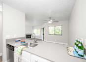 Thumbnail 15 of 25 - a kitchen with a sink and a dishwasher