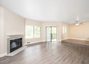 Thumbnail 16 of 25 - a living room with hardwood floors and a fireplace